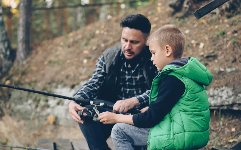 Parent fishing with child