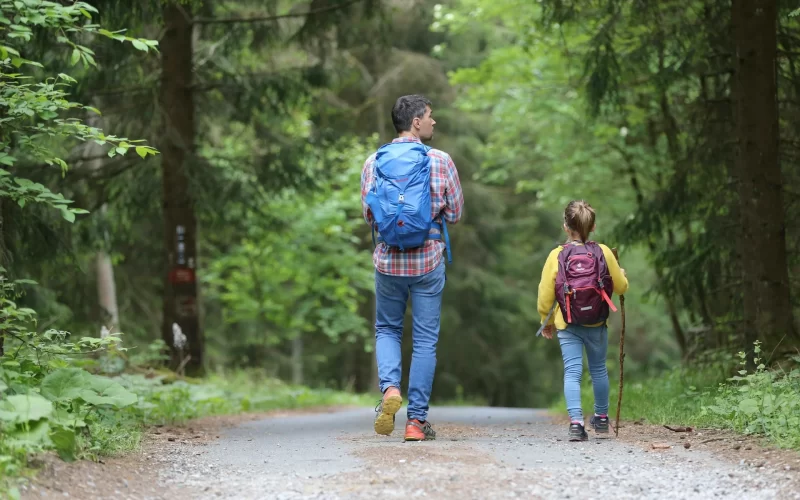 Kid hiking with dad
